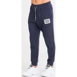 SPODNIE DRESOWE Emporio Armani. Niebieskie spodnie męskie Emporio Armani, na imprezę, xxl, z aplikacjami, z dresówki. Za 791,20 zł.