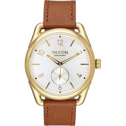 Zegarek kwarcowy "C39" w kolorze brązowo-biało-złotym. Pomarańczowe, analogowe zegarki męskie Nixon, złote. W wyprzedaży za 429,95 zł.
