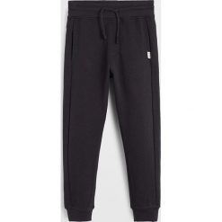 Mango Kids - Spodnie dziecięce Jumbo 110-164 cm. Niebieskie spodnie chłopięce Mango Kids, bez wzorów, z bawełny, casualowe. Za 69,90 zł.