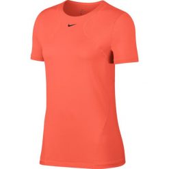 Koszulka Nike Pro All Over Mesh SS Top W Koralowa. Pomarańczowe topy damskie Nike, bez wzorów, z materiału, bez kołnierzyka, z krótkim rękawem, krótkie, bez kaptura, do biegania. Za 89,99 zł.