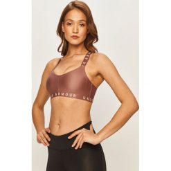Under Armour - Biustonosz sportowy. Różowe biustonosze sportowe damskie Under Armour, xs, z nadrukiem, z elastanu. Za 129,90 zł.