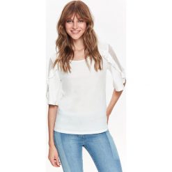 T-shirt damski krótki rękaw z falbanami. Białe t-shirty damskie z jeansu, eleganckie. W wyprzedaży za 19,99 zł.