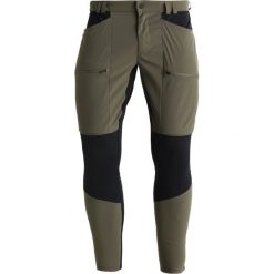 Peak Performance TRACK Spodnie materiałowe terrain green. Brązowe spodnie męskie marki Peak Performance, m, bez wzorów, z elastanu, sportowe, długie. W wyprzedaży za 399,50 zł.