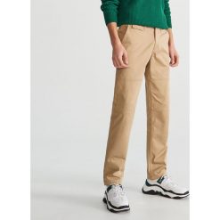 Bawełniane spodnie chino - Beżowy. Brązowe chinosy męskie marki Reserved, m, z bawełny. Za 129,99 zł.