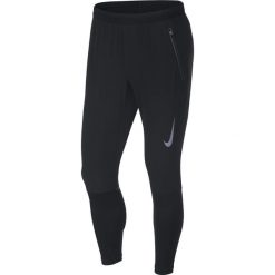 Spodnie do biegania męskie NIKE SWIFT RUN PANT / 928583-010. Czarne spodnie męskie Nike, m, bez wzorów. Za 399,00 zł.