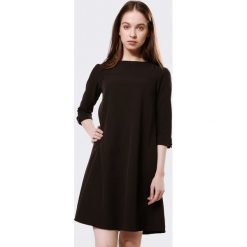 Czarna Sukienka Then. Czarne sukienki damskie Born2be, s, bez wzorów, z tkaniny, z okrągłym kołnierzem, bez rękawów, mini, trapezowe. Za 49,99 zł.