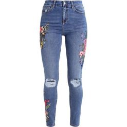 Topshop TUCAN Jeans Skinny Fit middenim. Niebieskie rurki damskie marki Topshop. W wyprzedaży za 271,20 zł.