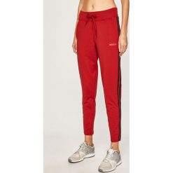 Adidas - Spodnie. Czerwone spodnie damskie Adidas, s, z elastanu. W wyprzedaży za 179,90 zł.