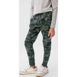 Mango Kids - Spodnie dziecięce Fossil6 110-164 cm. Niebieskie spodnie chłopięce Mango Kids, bez wzorów, z elastanu. Za 69,90 zł.