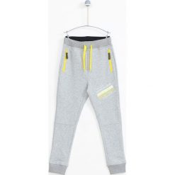 Lemon Explore - Spodnie dziecięce 122-164 cm. Szare spodnie chłopięce LEMON explore, z nadrukiem, z bawełny, sportowe. W wyprzedaży za 59,90 zł.