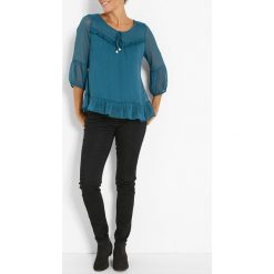 Tunika w kolorze niebieskim. Niebieskie tuniki damskie Jacqueline Riu, bez wzorów, klasyczne, z okrągłym kołnierzem, bez rękawów. W wyprzedaży za 57,95 zł.