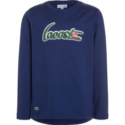 Lacoste Bluzka z długim rękawem methylene. Niebieskie bluzki dziewczęce Lacoste, z bawełny, z długim rękawem. Za 159,00 zł.