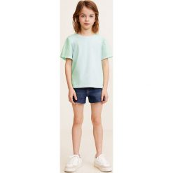 Mango Kids - Top dziecięcy Mixa 110-164 cm. Białe bluzki dziewczęce Mango Kids, bez wzorów, z bawełny, z okrągłym kołnierzem, z krótkim rękawem, krótkie, bez kaptura. Za 35,90 zł.
