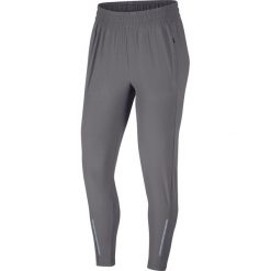 Spodnie Nike Swift Trousers W Szare. Szare spodnie damskie Nike, uniwersalny, bez wzorów, z materiału, do biegania, dri-fit (nike). Za 319,99 zł.
