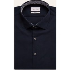 Calvin Klein - Koszula. Niebieskie koszule męskie Calvin Klein, bez wzorów, z bawełny, eleganckie, z klasycznym kołnierzykiem, z długim rękawem. W wyprzedaży za 199,90 zł.