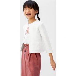 Mango Kids - Kardigan dziecięcy Coco 110-164 cm. Białe swetry dziewczęce Mango Kids, bez wzorów, z bawełny, bez kołnierzyka, bez rękawów, bez kaptura. W wyprzedaży za 49,90 zł.