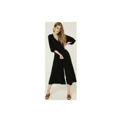 Kombinezon Janis - czerń. Czarne kombinezony damskie marki Madnezz, s, bez wzorów, z elastanu, eleganckie, bez kołnierzyka, bez rękawów. Za 359,00 zł.
