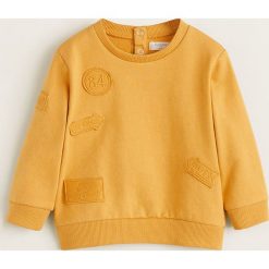 Mango Kids - Bluza dziecięca Most 80-104 cm. Żółte bluzy chłopięce Mango Kids, z aplikacjami, z bawełny, bez rękawów, bez kaptura. W wyprzedaży za 35,90 zł.
