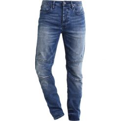 Cristiano Ronaldo CR7 Jeansy Slim Fit oasis. Niebieskie jeansy męskie relaxed fit marki Cristiano Ronaldo CR7. W wyprzedaży za 251,40 zł.