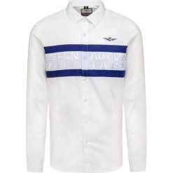 Koszula AERONAUTICA MILITARE. Białe koszule męskie Aeronautica Militare, bez wzorów, z bawełny, z kontrastowym kołnierzykiem, bez rękawów. Za 550,00 zł.
