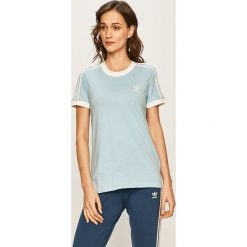 Adidas Originals - T-shirt. Niebieskie topy damskie adidas Originals, z aplikacjami, z elastanu, casualowe, z okrągłym kołnierzem. W wyprzedaży za 99,90 zł.