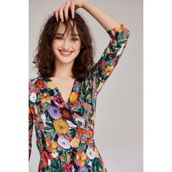 Sukienka Rita Canna pomarańczowa 46 wielokolorowy. Pomarańczowe sukienki damskie na jesień, w kwiaty, z elastanu, rozkloszowane. Za 347,00 zł.