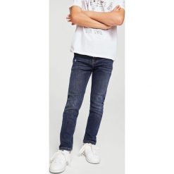 Mango Kids - Jeansy dziecięce Jacob 104-164 cm. Niebieskie spodnie chłopięce marki Mango Kids, z elastanu. W wyprzedaży za 49,90 zł.