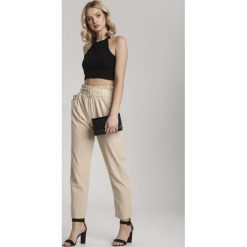 Beżowe Spodnie Adreameda. Brązowe spodnie damskie Renee, xl, bez wzorów, z tkaniny, eleganckie, z podwyższonym stanem, długie. Za 79,99 zł.