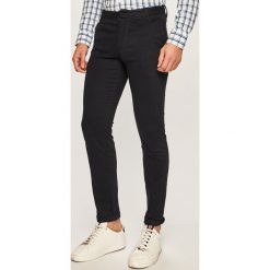 Armani Exchange - Spodnie. Czarne spodnie męskie Armani Exchange, na co dzień, z haftami, z elastanu, casualowe. Za 419,90 zł.