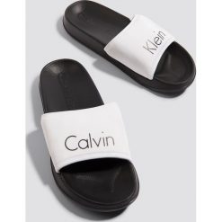 Calvin Klein Klapki - Black,White,Multicolor. Białe chodaki damskie Calvin Klein, w paski, z gumy. Za 161,95 zł.