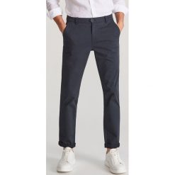 Dopasowane spodnie chino - Granatowy. Niebieskie spodnie męskie Reserved, m, bez wzorów. Za 129,99 zł.