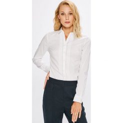 Tommy Hilfiger - Koszula Roya. Białe koszule damskie TOMMY HILFIGER, bez wzorów, z bawełny, klasyczne, z klasycznym kołnierzykiem, z długim rękawem. W wyprzedaży za 289,90 zł.
