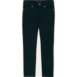 Tommy Hilfiger - Spodnie dziecięce 128-176 cm. Niebieskie spodnie chłopięce TOMMY HILFIGER, bez wzorów, z elastanu. W wyprzedaży za 219,90 zł.