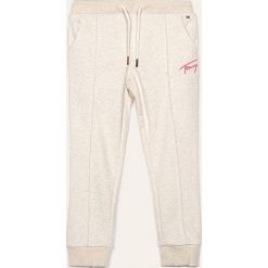 Tommy Hilfiger - Spodnie dziecięce 110-176 cm. Białe spodnie dziewczęce TOMMY HILFIGER, m, bez wzorów, z bawełny. W wyprzedaży za 179,90 zł.