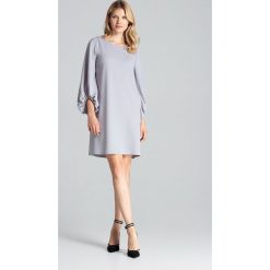 Sukienka trapezowa z szerokimi rękawami szara - s/m. Szare sukienki damskie e-margeritka.pl, na co dzień, s, bez wzorów, z elastanu, eleganckie, bez kołnierzyka, z długim rękawem, długie, midi, proste. Za 174,99 zł.