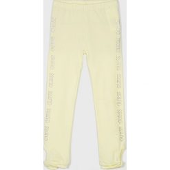 Guess Jeans - Legginsy dziecięce 118-166 cm. Żółte spodnie dziewczęce wzorzyste Guess Jeans, m, z elastanu, z podwyższonym stanem. Za 99,90 zł.