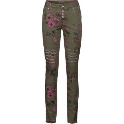 Spodnie Skinny bonprix ciemnooliwkowy w kwiaty. Zielone spodnie damskie bonprix, z aplikacjami. Za 149,99 zł.