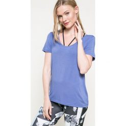 Reebok - Top. Niebieskie topy sportowe damskie marki Reebok, m, z dzianiny, z okrągłym kołnierzem. W wyprzedaży za 49,90 zł.
