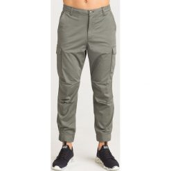 SPODNIE Armani Exchange. Brązowe spodnie męskie Armani Exchange, na co dzień, m, bez wzorów, z elastanu. Za 305,00 zł.