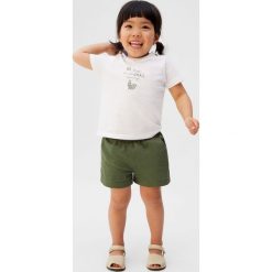 Mango Kids - Szorty dziecięce Monica 80-104 cm. Żółte spodenki dziewczęce Mango Kids, bez wzorów, z bawełny, casualowe. W wyprzedaży za 49,90 zł.