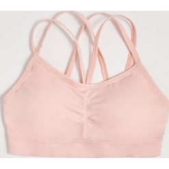 Biustonosz typu top - Różowy. Różowe biustonosze Sinsay, bez wzorów. Za 19,99 zł.