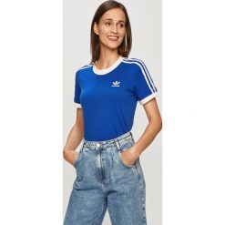 Adidas Originals - T-shirt. Niebieskie topy damskie adidas Originals, z aplikacjami, z elastanu, casualowe, z okrągłym kołnierzem. Za 129,90 zł.