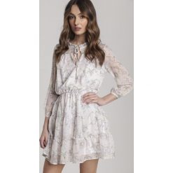 Jasnobeżowa Sukienka Kaigana. Brązowe sukienki damskie Renee, s, bez wzorów, bez kołnierzyka, bez rękawów, mini. Za 129,99 zł.