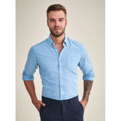 Koszula w kolorze jasnoniebieskim. Niebieskie koszule męskie TATUUM, xl, bez wzorów, z bawełny, z klasycznym kołnierzykiem, bez rękawów. W wyprzedaży za 84,95 zł.