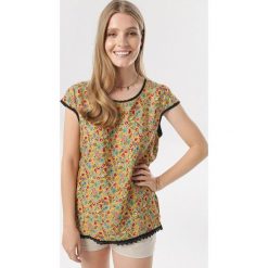 Żółta Bluzka Titania. Żółte bluzki damskie Born2be, xl, bez wzorów, bez kołnierzyka, bez rękawów. W wyprzedaży za 24,99 zł.