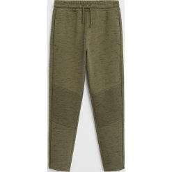 Mango Kids - Spodnie dziecięce Man 110-164 cm. Żółte spodnie chłopięce Mango Kids, bez wzorów, z bawełny. W wyprzedaży za 49,90 zł.