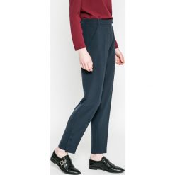Tommy Hilfiger - Spodnie. Niebieskie spodnie damskie TOMMY HILFIGER, z elastanu, z podwyższonym stanem. W wyprzedaży za 269,90 zł.