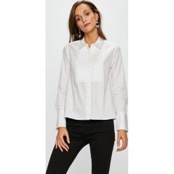 Tommy Hilfiger - Koszula. Białe bluzki damskie TOMMY HILFIGER, na co dzień, bez wzorów, z bawełny, klasyczne, z klasycznym kołnierzykiem, z długim rękawem. W wyprzedaży za 299,90 zł.