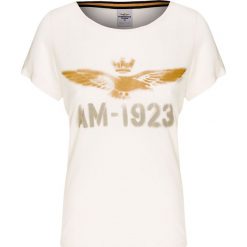 T-shirt AERONAUTICA MILITARE Beżowy. Brązowe t-shirty damskie marki Aeronautica Militare, z nadrukiem, z bawełny, militarne, z kontrastowym kołnierzykiem. W wyprzedaży za 128,00 zł.