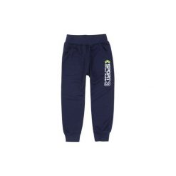 Spodnie chłopięce ze ściągaczami cienkie, dresowe. Niebieskie chinosy chłopięce TXM, z dresówki. Za 14,99 zł.